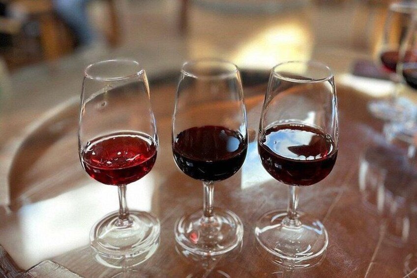 Three wine glasses on a table. 2