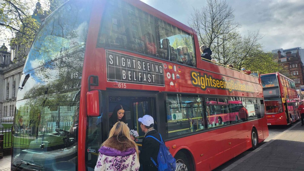A red double-decker bus with 'Sightseeing Belfast' written on it. 2