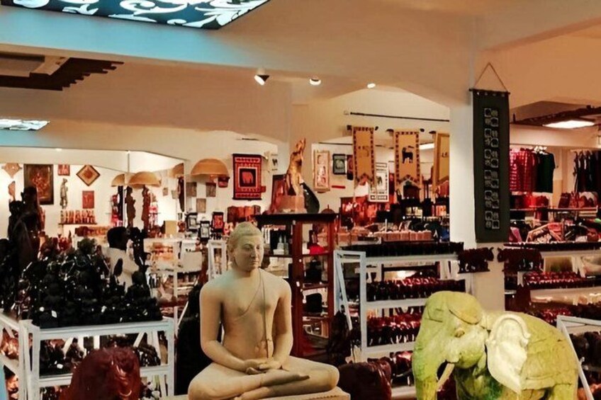 A store interior with a Buddha statue, shelves of shoes, and various decorative items. 5
