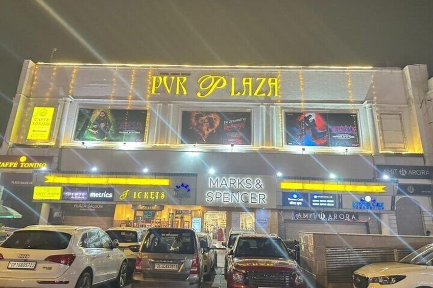 A building with 'PVR Plaza' signage, 'Marks & Spencer' store, and 'Cafe Toning' on the left. 5