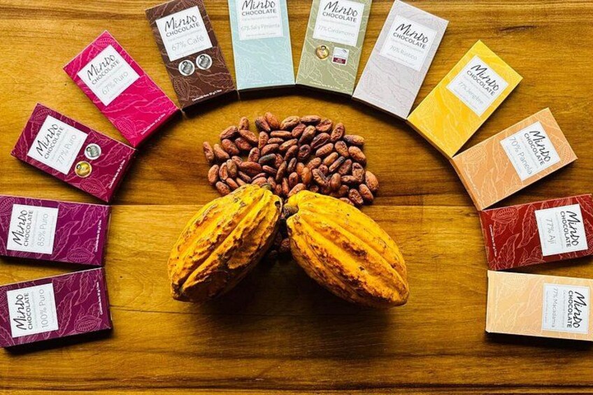 Various chocolate bars and cocoa beans arranged on a wooden surface. 3