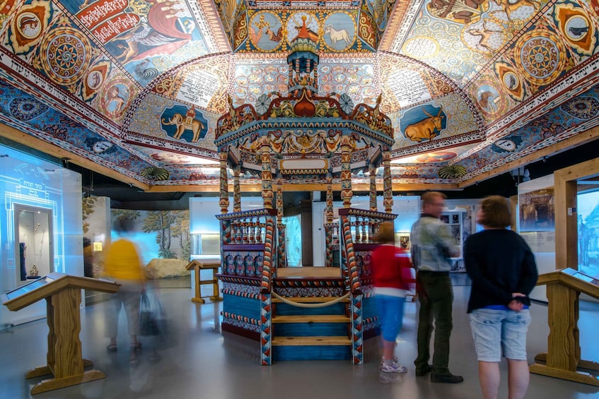 A room with a colorful, intricately decorated ceiling and a central ornate structure. 4