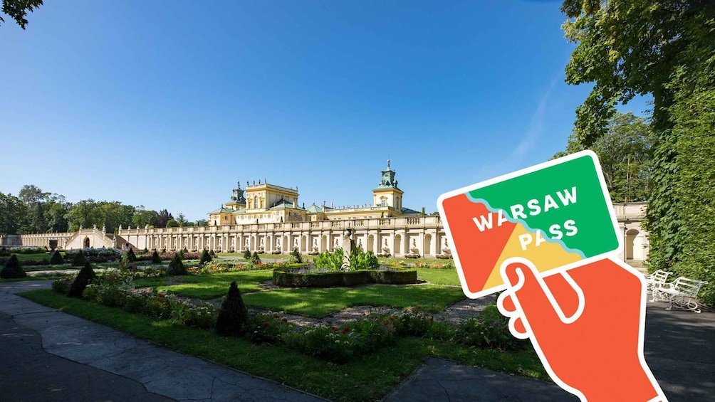A Warsaw Pass sign in front of a historic building with a garden. 1