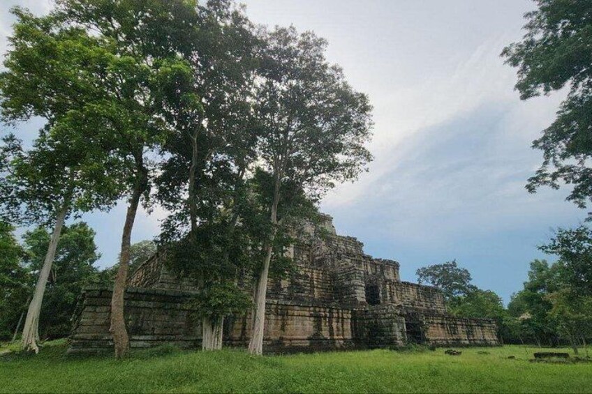 An ancient stone structure surrounded by trees. 3