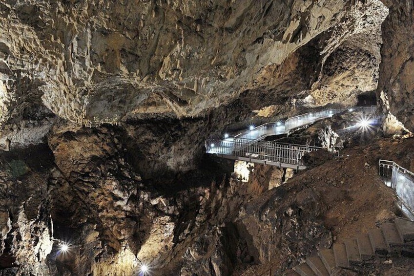 A cave with a metal walkway. 3