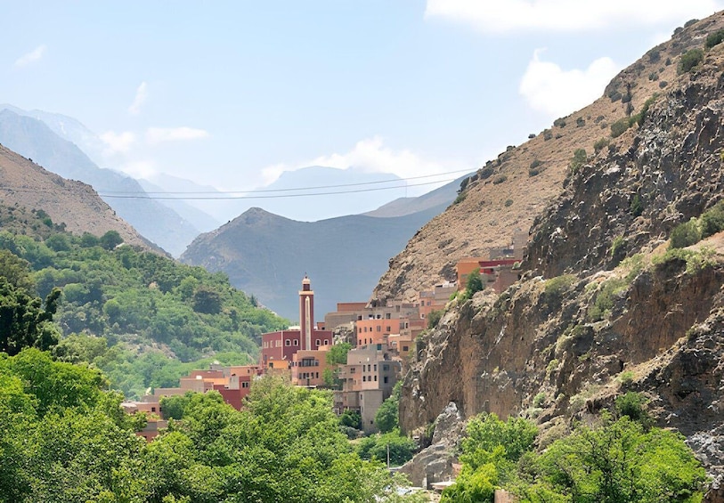 A village nestled in a valley with a prominent minaret. 1