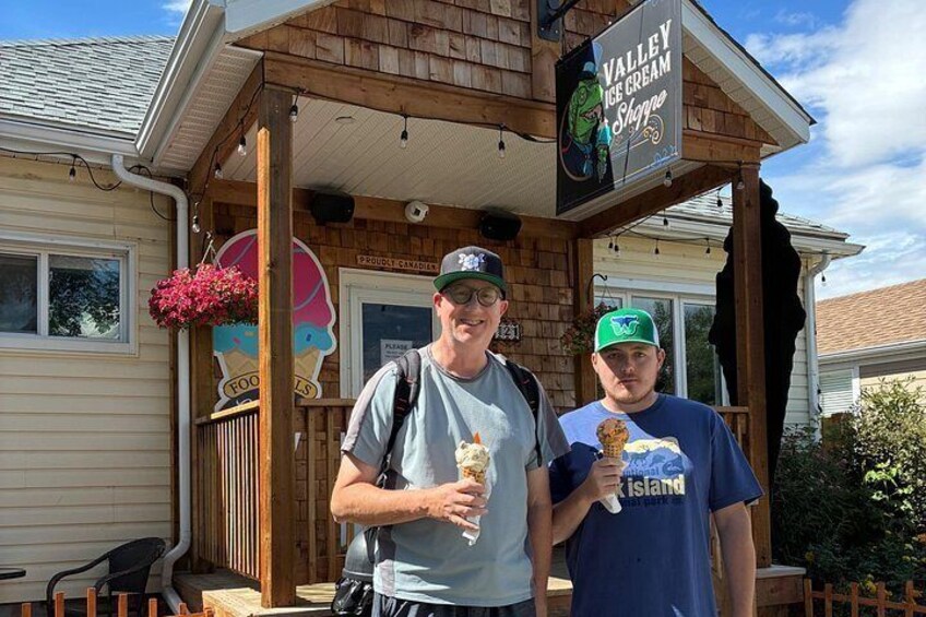 Two people standing in front of a building with a sign that reads 'Valley Ice Cream Shoppe.' 5
