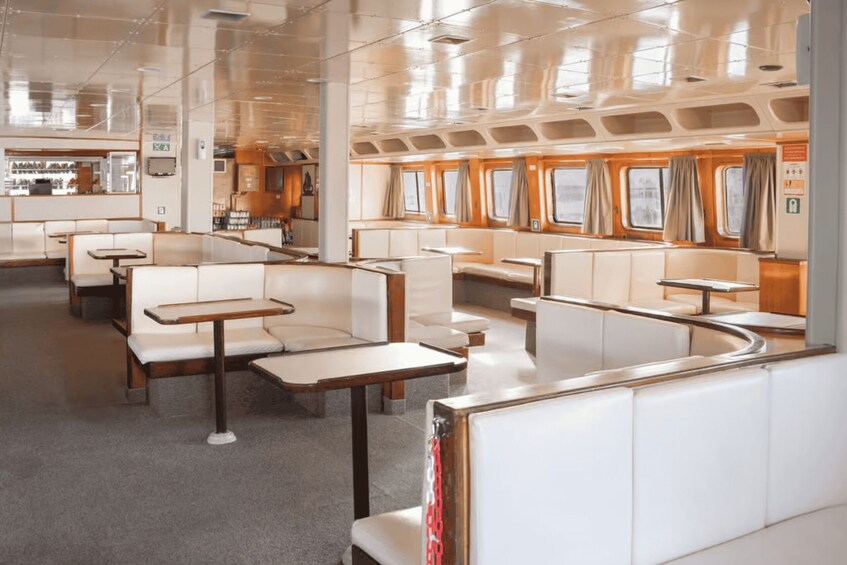 A modern interior with seating areas, tables, and windows. 4