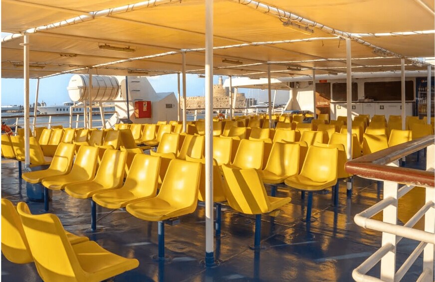A deck with yellow chairs and a large yellow canopy. 3
