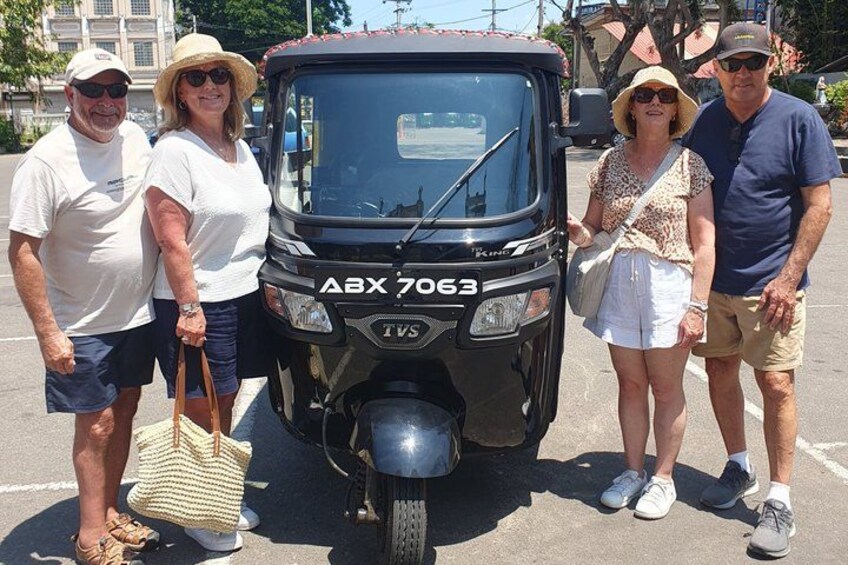 A black ATV with the license plate ABX 7063 parked in a parking lot. 2