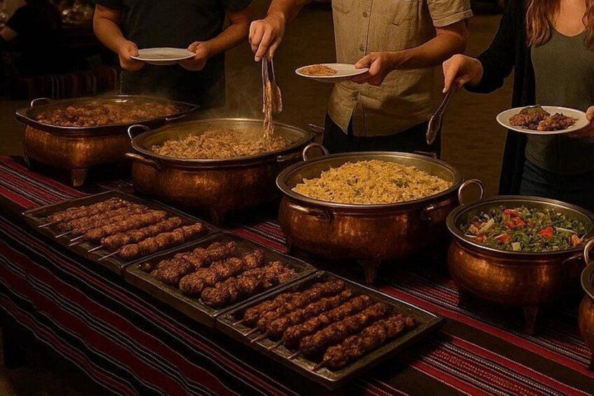 A buffet with various dishes in large pots and trays. 2
