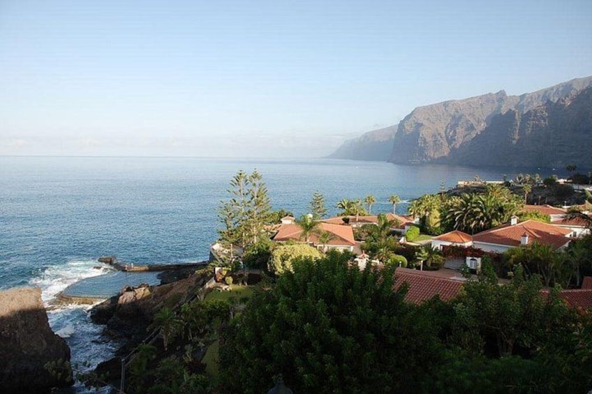 Un village côtier avec des maisons, des falaises et l’océan. 2