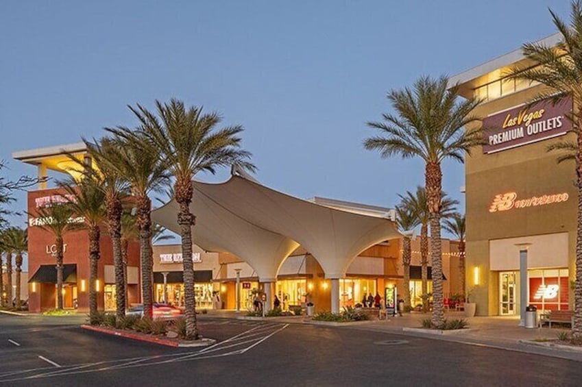 A hotel with a large canopy and palm trees in front. 4