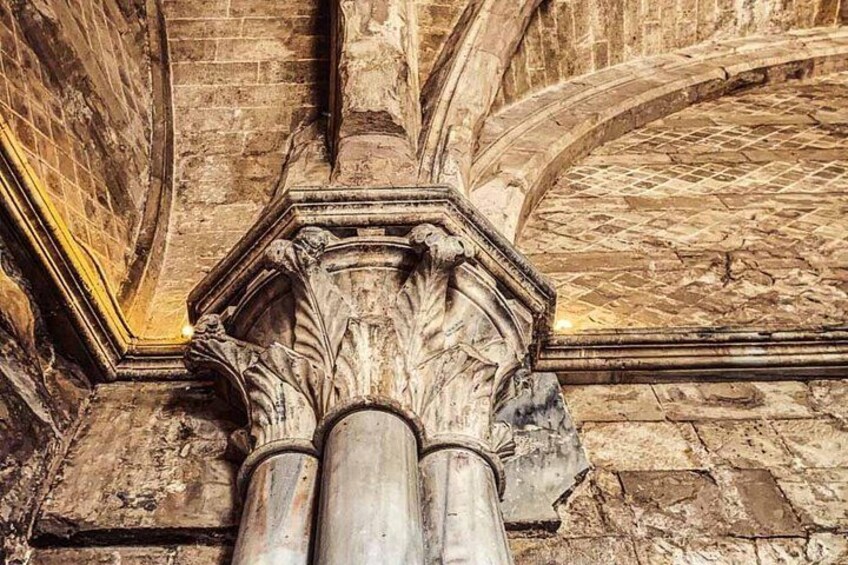 A stone column with intricate carvings in a historical building. 4