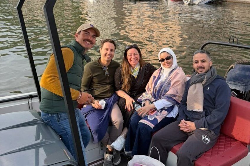 A group of people on a boat with calm water in the background. 2