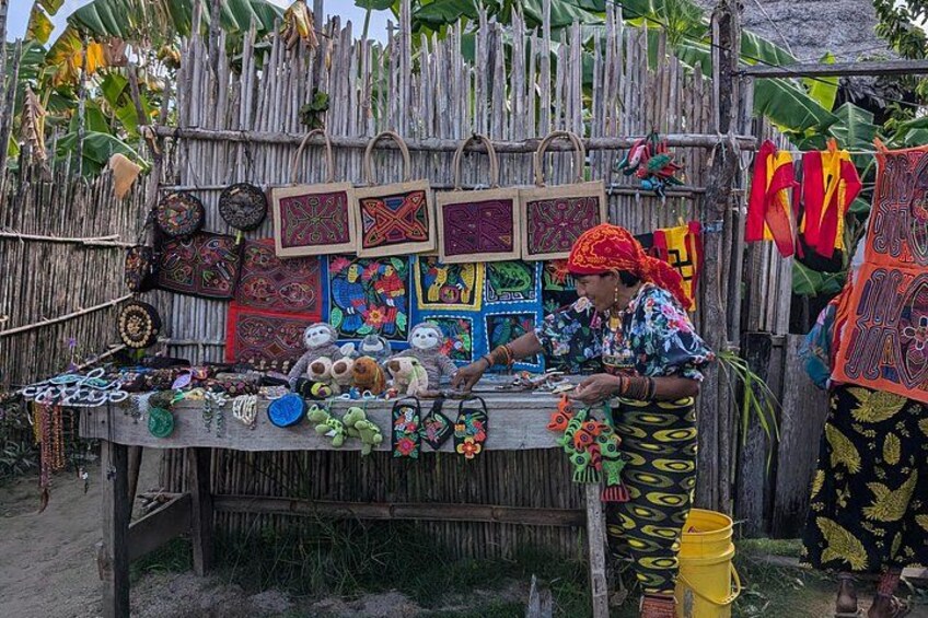 A person selling colorful woven baskets and textiles at a market stall. 3