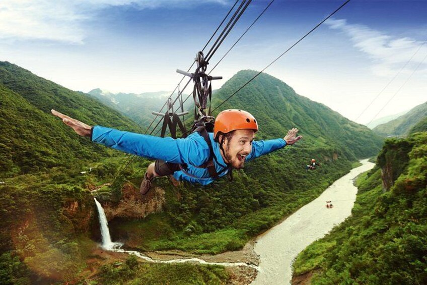 A person bungee jumping with a river and mountains in the background. 3