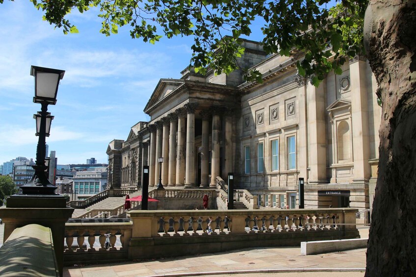 A classical building with columns and a staircase leading to the entrance. 5