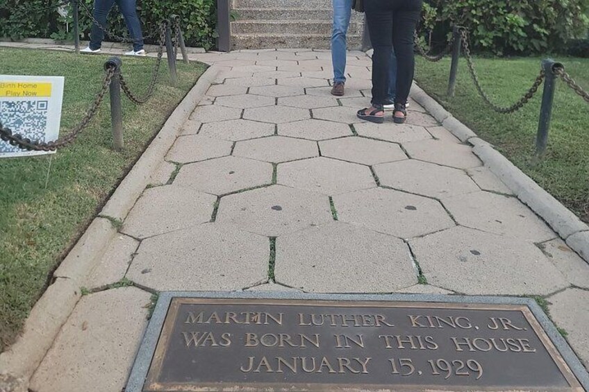 A hexagonal paved pathway with a historical plaque stating 'Martin Luther King, Jr. was born in this house January 15, 1929.' 3