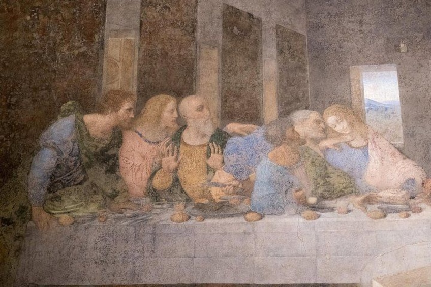 A fresco of a group of people seated around a table, with architectural elements in the background. 3