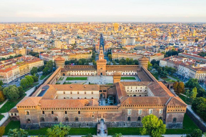 A large historic building complex with a prominent tower and a central courtyard. 2