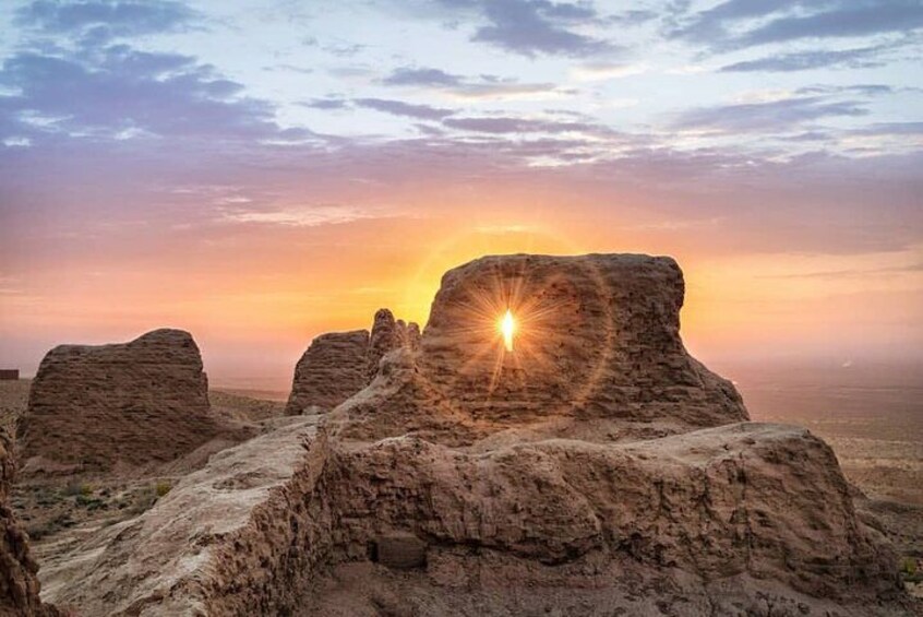 A desert landscape with rock formations at sunset. 3