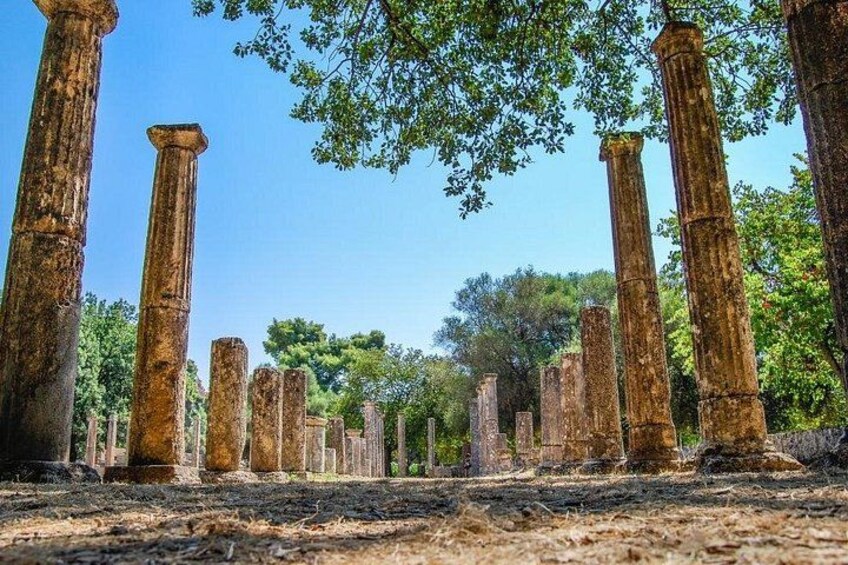 Ancient stone columns in a forested area. 1