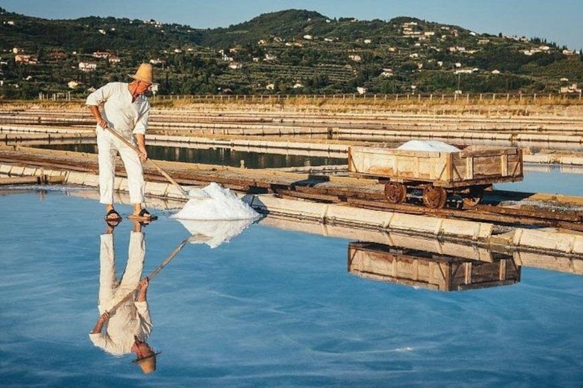 A person working in a salt flat with a cart and a large white block. 2