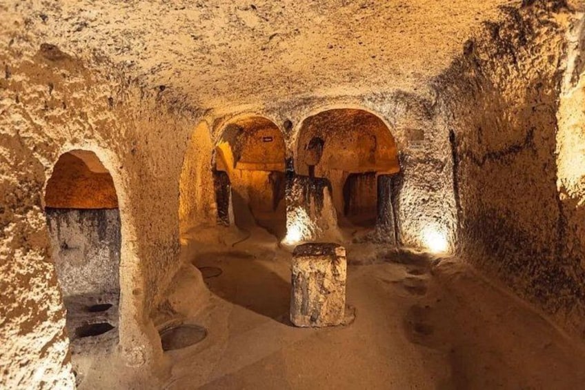 A cave with arched openings and a central pillar. 4