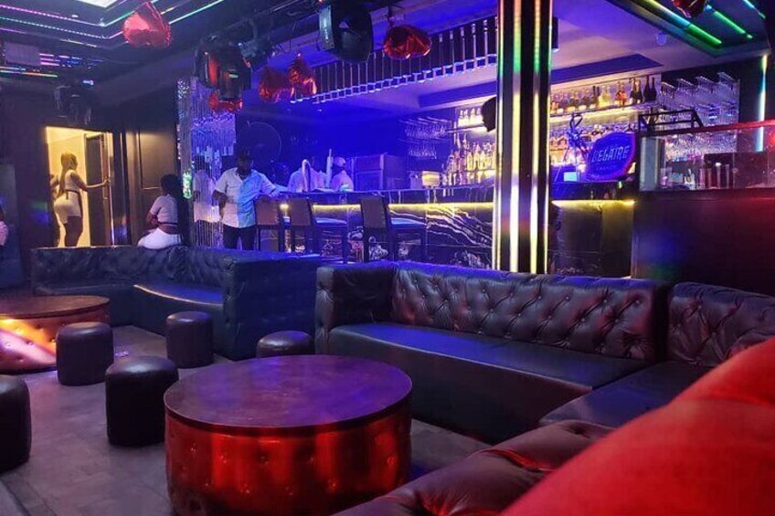 A bar with leather seating and a bar counter. 2