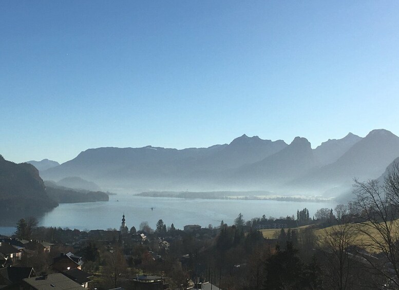 Un lago rodeado de montañas, un pueblo pequeño y una iglesia. 1