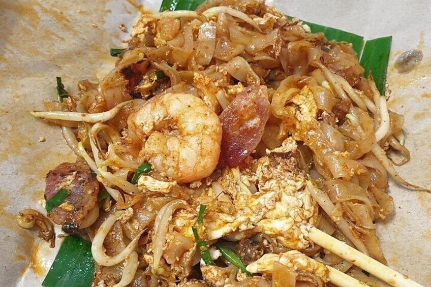 A dish of Pad Thai noodles with shrimp, egg, and vegetables. 1