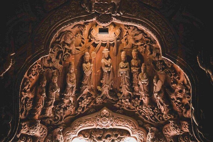 A detailed carved wooden panel with religious figures and intricate designs. 3