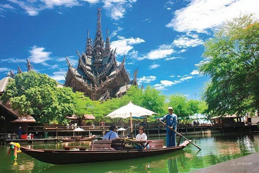 A traditional boat on a river with a temple in the background. 5