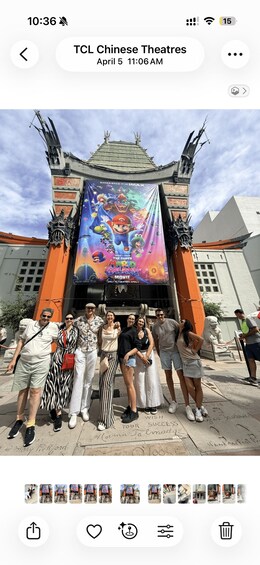A group of people posing in front of TCL Chinese Theatres with a Mario movie poster. 2