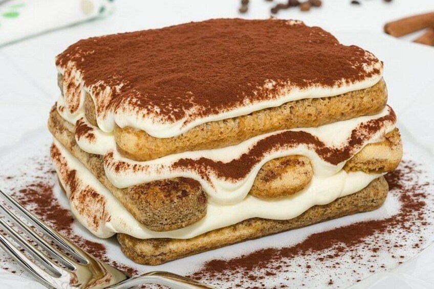 A layered dessert with a dusting of cocoa powder on top. 5
