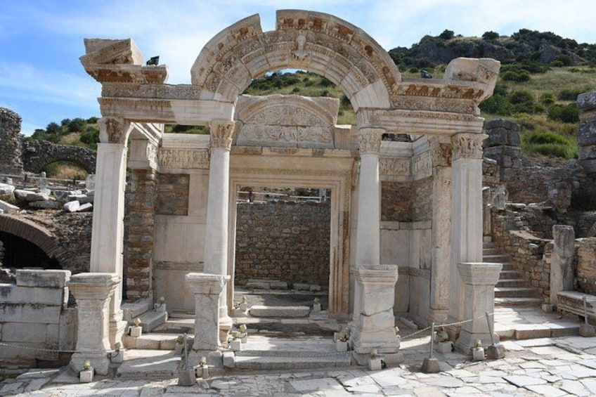 Ancient ruins with columns and an arched entrance. 2