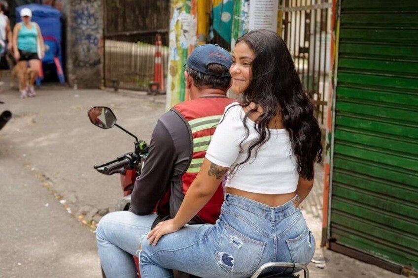 A person riding a motorcycle with a passenger. 1