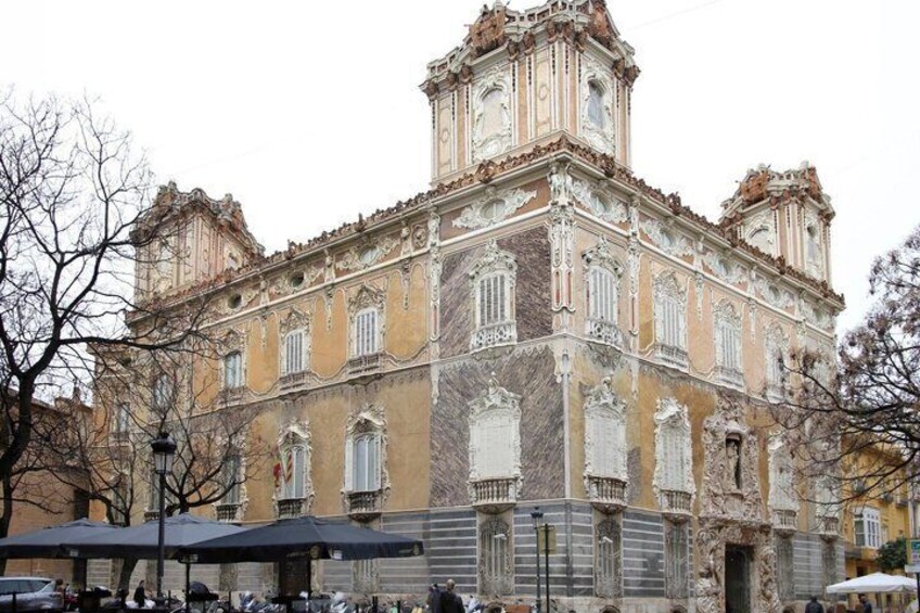A historic building with ornate architecture, including a clock tower and decorative windows. 4