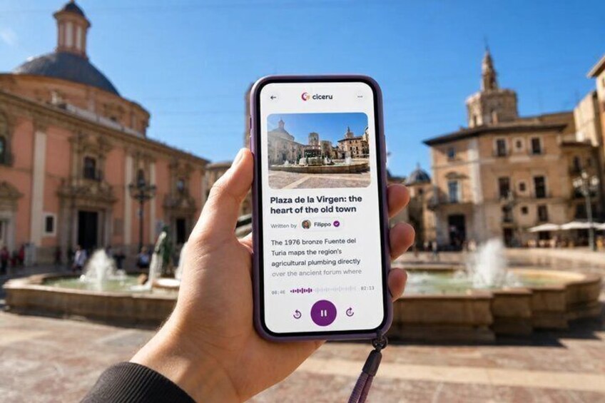 A hand holding a smartphone displaying a historical article about Plaza de la Virgen. 1