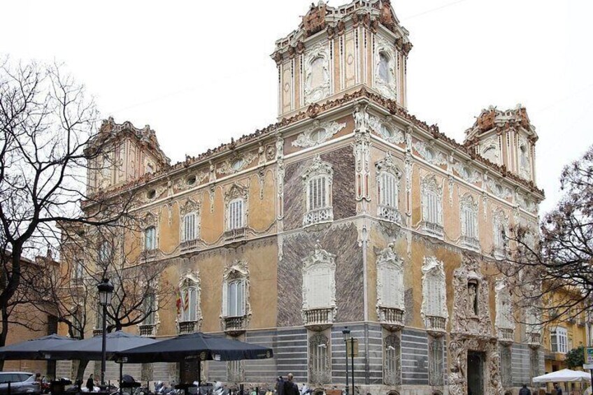 A historic building with ornate architecture, including a clock tower and decorative windows. 3