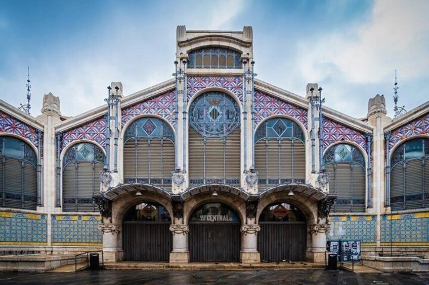 A historic building with ornate architecture, large arched windows, and decorative tiles. 5