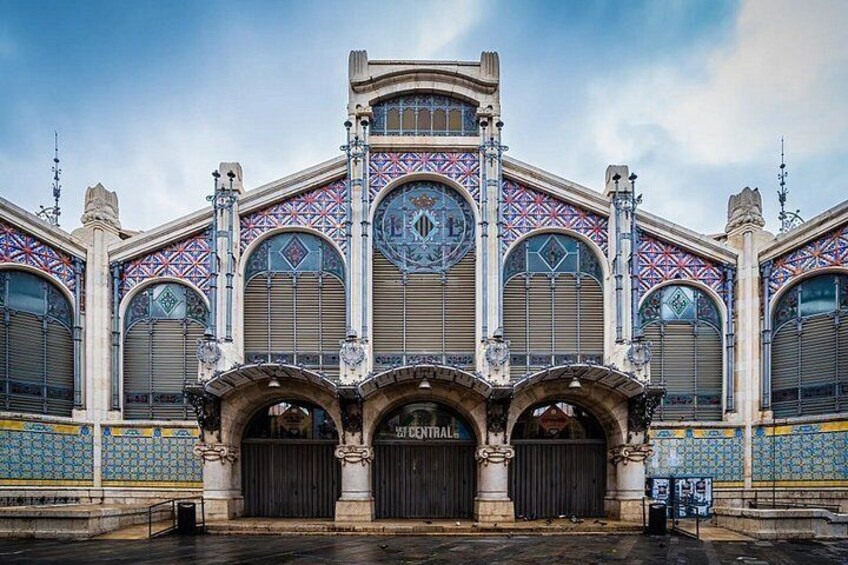 A building with ornate architecture, featuring large arched windows and decorative tiles. 4
