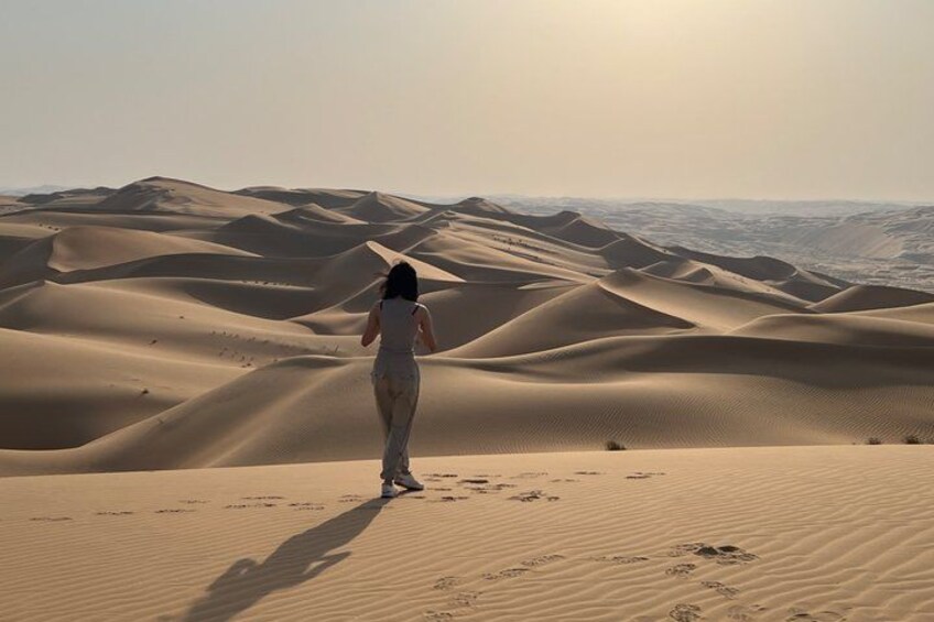 A person walking on a sand dune in a desert landscape. 3