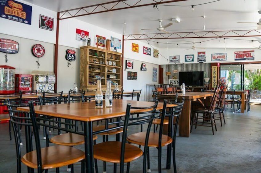 A diner with vintage decor, including gas pump signs and a jukebox. 3