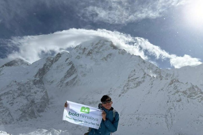 A person holding a banner with 'bold Himalaya' text, standing in front of snow-covered mountains. 4