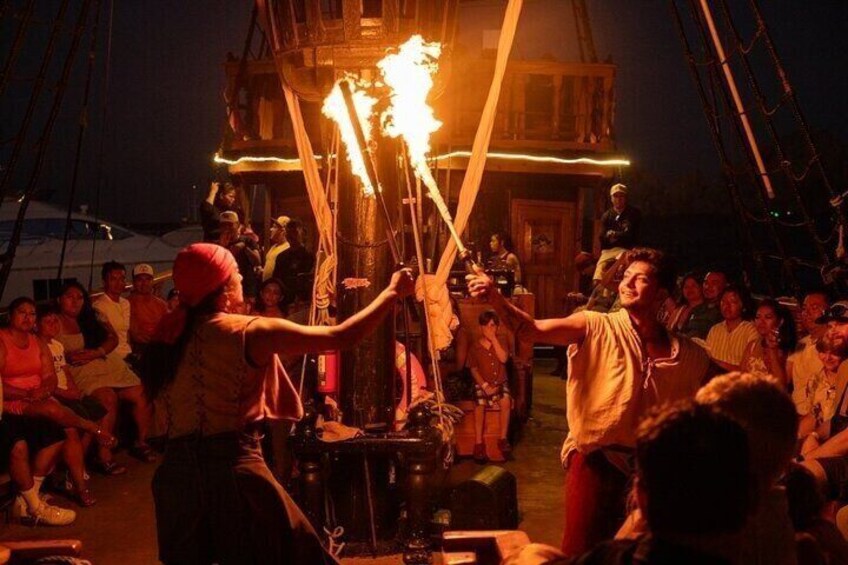 A group of people gathered around a wooden structure with torches being held aloft. 4