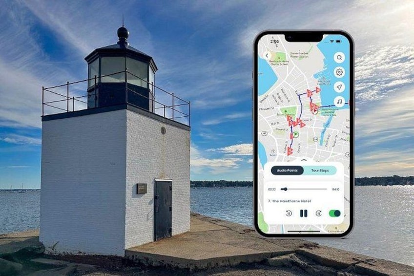 A lighthouse by the water with a smartphone displaying a map. 1