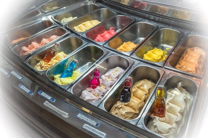 A beverage dispenser with multiple compartments containing various drinks and condiments. 2