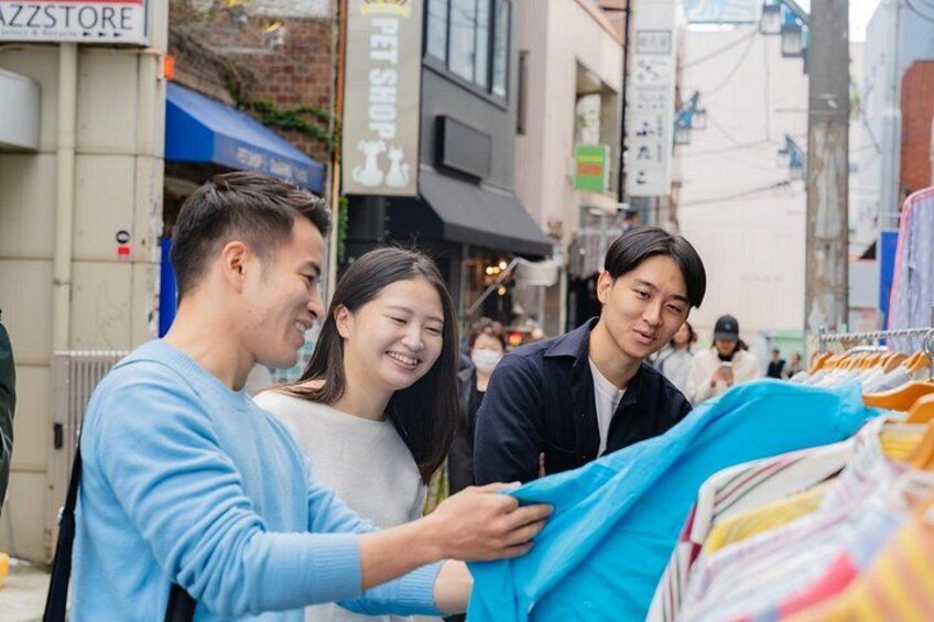 A street market with people browsing items. 4